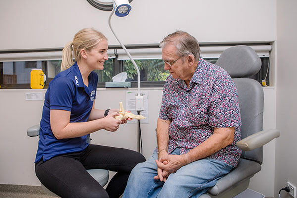 Image representing jobs and careers at Wesley Mission Queensland, Brisbane. It shows allied health staff with senior resident during a private physiotherapy consultation