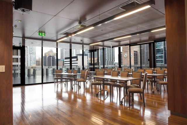 Large room with polished floors, chiars and tables