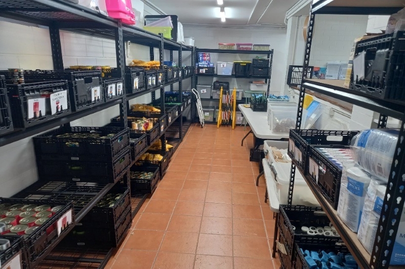 Storage shelves with food lining the walls of the Brisbane Relief Hub pantry