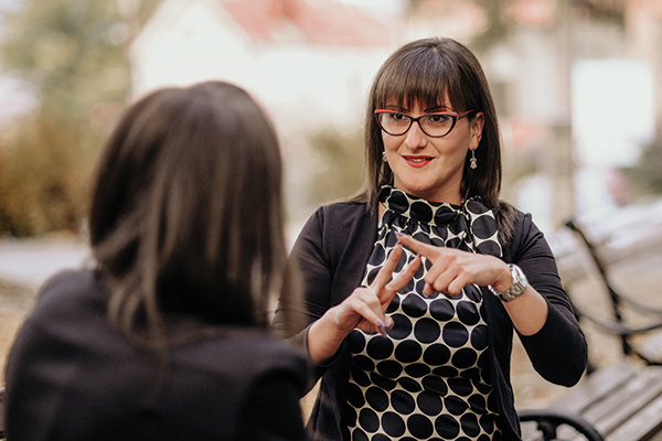 A NABS Auslan sign language interpreter in a park in Brisbane