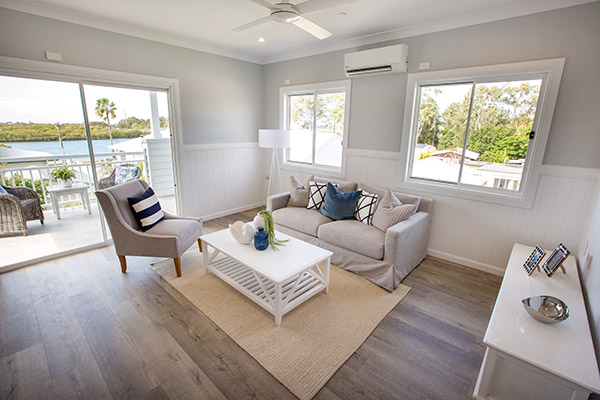 Living room with water views in our Hamptons style Specialist Disability Accommodation in Hope Island, Gold Coast