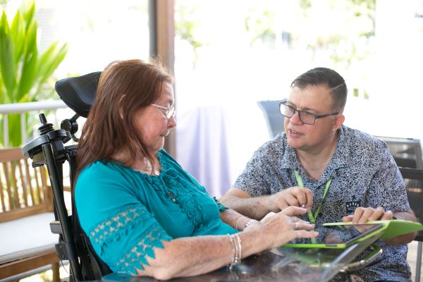 WesleyCare Tewantin resident on ipad with support staff