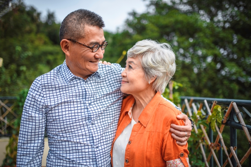 Son and elderly mother, embracing and smiling