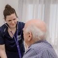 Nurse checks patient with stethoscope
