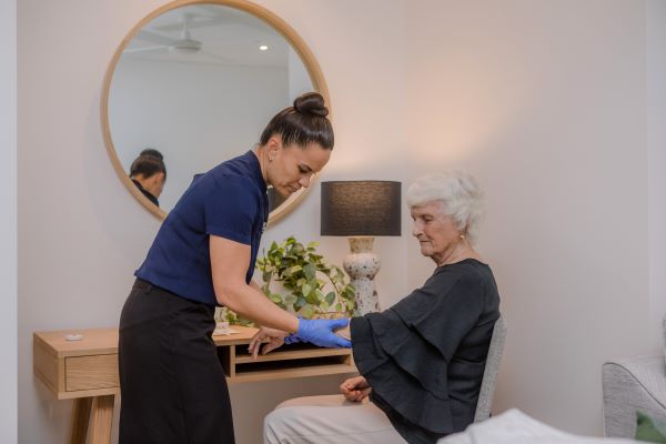 Staff member massaging client's arm