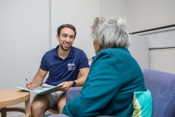 A speech pathologist chats with a client  in one of our residential aged care communities in Brisbane