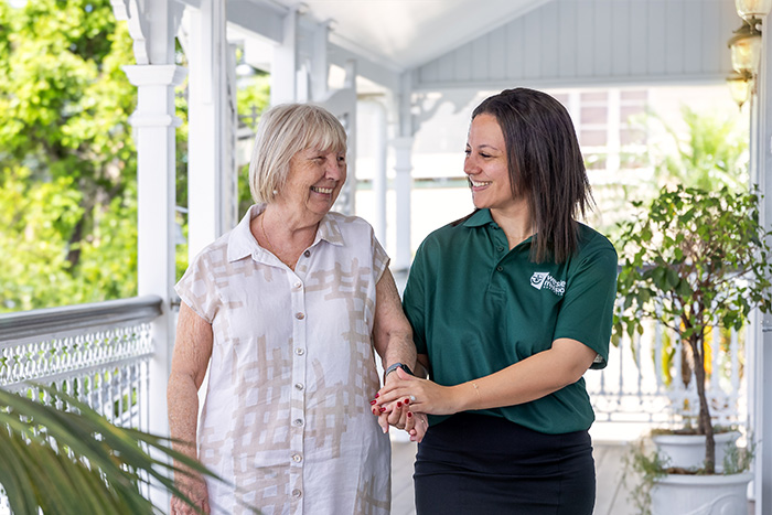 Home Care Brisbane - Staff and retiree chatting outdoors