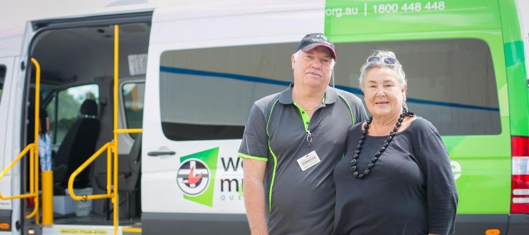 Lady and man standing in front of WMQ transport van