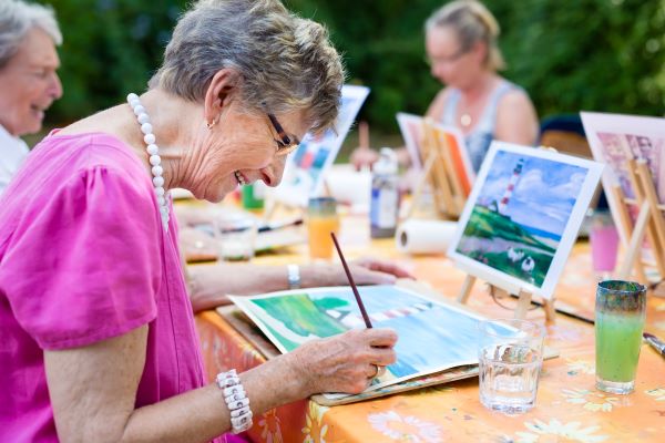 Residents painting as part of the Community program