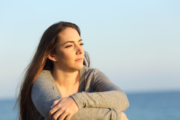 Woman looking thoughtful on beach