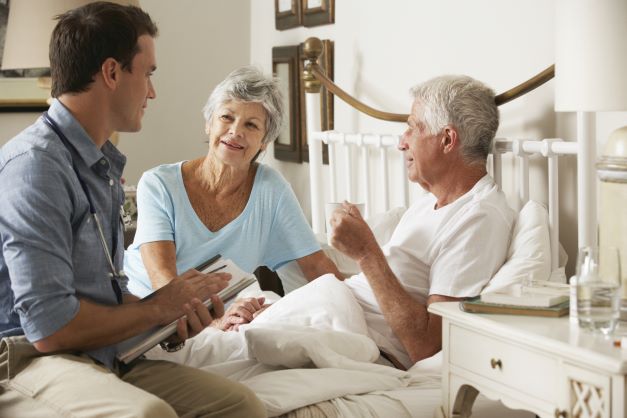 Doctor visits a patient at home through Hopewell Outreach, our respite home care service