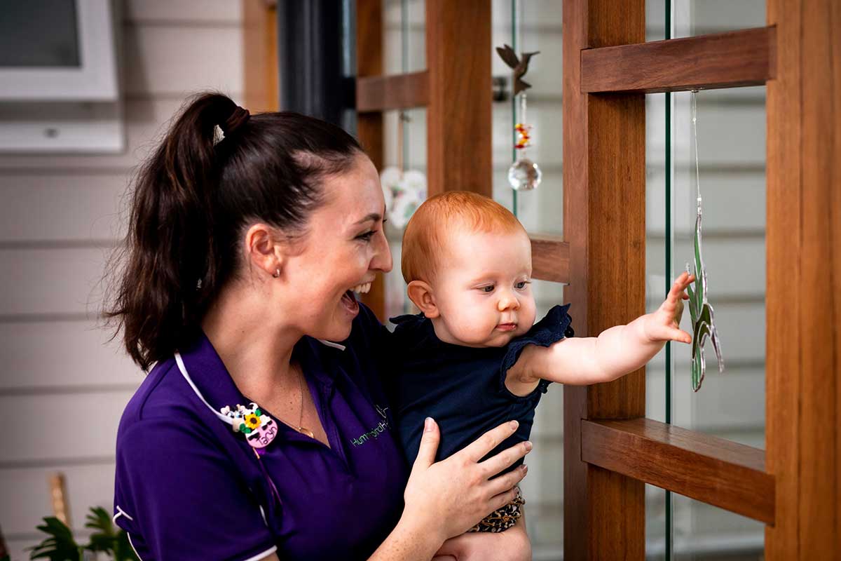 Precious moments at Hummingbird House - Happy staff holding a cute baby