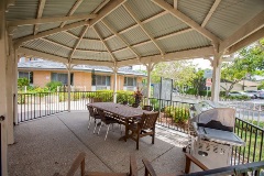 Outdoor gazebo area with BBQ and table and chairs