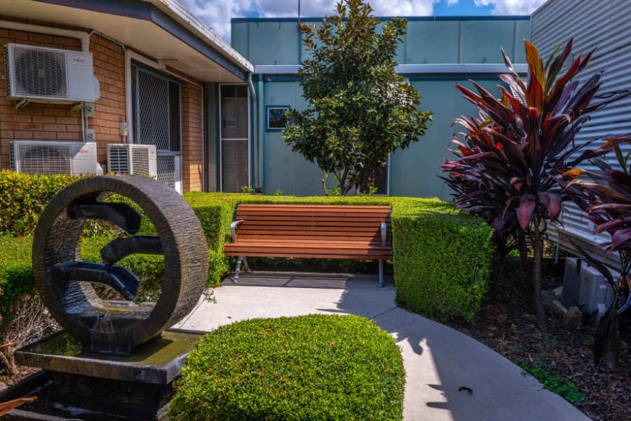 Emmaus sculpture and green outdoor area