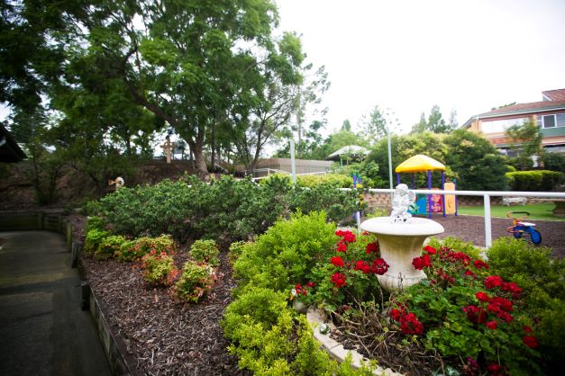 Outdoor garden area and playground at Nash Court