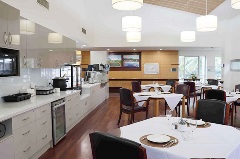 Kitchen overlooking dining room with chairs and tables