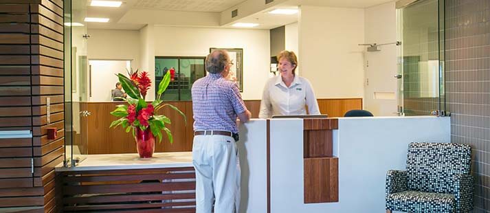 Welcoming reception desk staff and resident