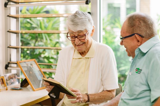 Resident admiring old photographs in a residential aged care respite community in Brisbane