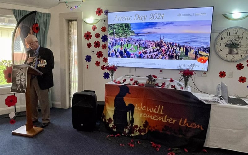 Image show speaker and a ANZAC Day 2024 display at St Marks community