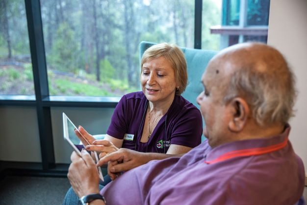 Aged care resident talks to a WMQ staff about ACAT and aged care services.