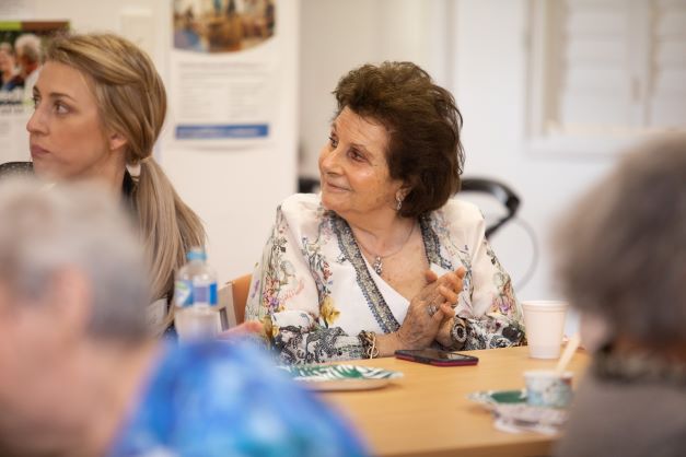 Elderly lady sitting and smiling