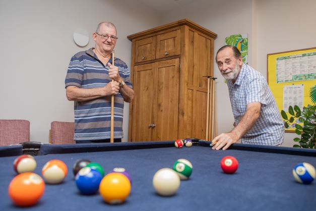 Two men playing a game of pool
