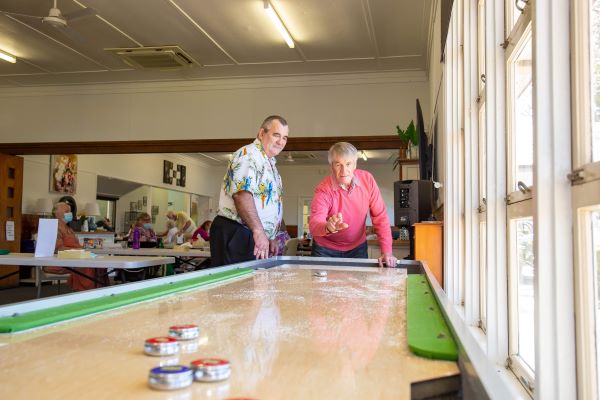 Hyland House residents play shuffleboard
