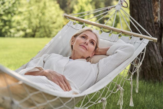 Living Well respite guest relaxing on hammock outdoors