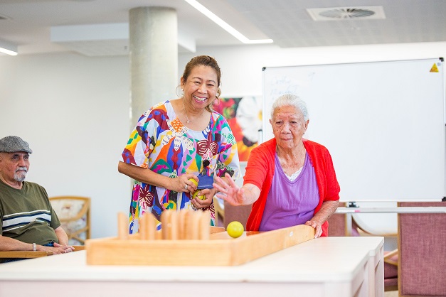 A lady playing table bowls