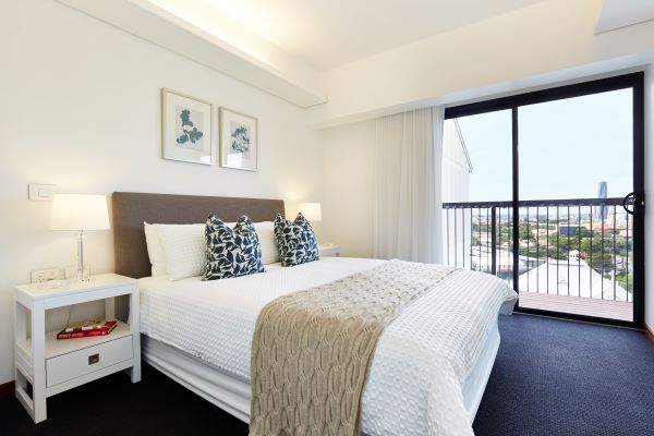 Bedroom at Aldersgate with view of city over balcony