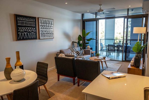 Open plan living and dining area with adjoining balcony