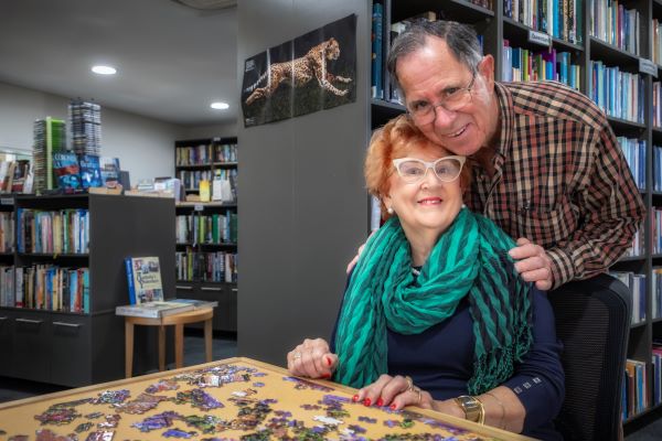 Resident Couple completes a  jigsaw in the library at Rosemount