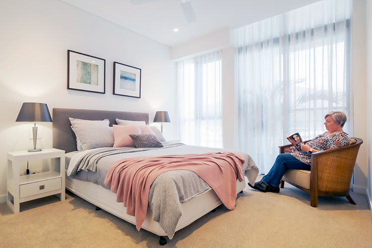 Lady reading a book in bedroom