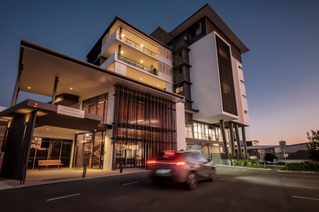 Exterior building at dusk with car driving by