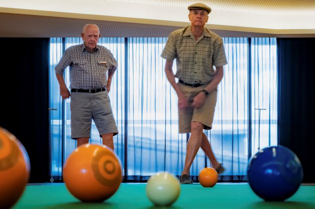 Two men playing bowls