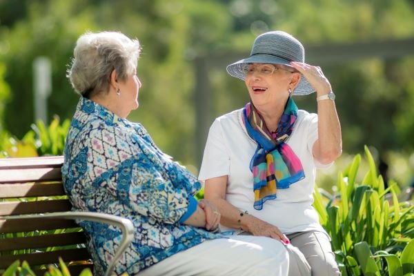 Two ladies talking in gardens of Wheller on the Park retirement village, in Chermside, Brisbane