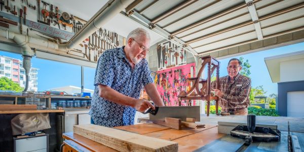 Residents cut wood in the workshop at Wheller on the Park