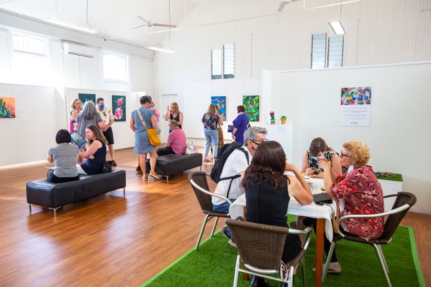 Art from the Margins gallery with people  enjoying an exhibition
