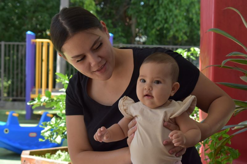 Mother holding young baby