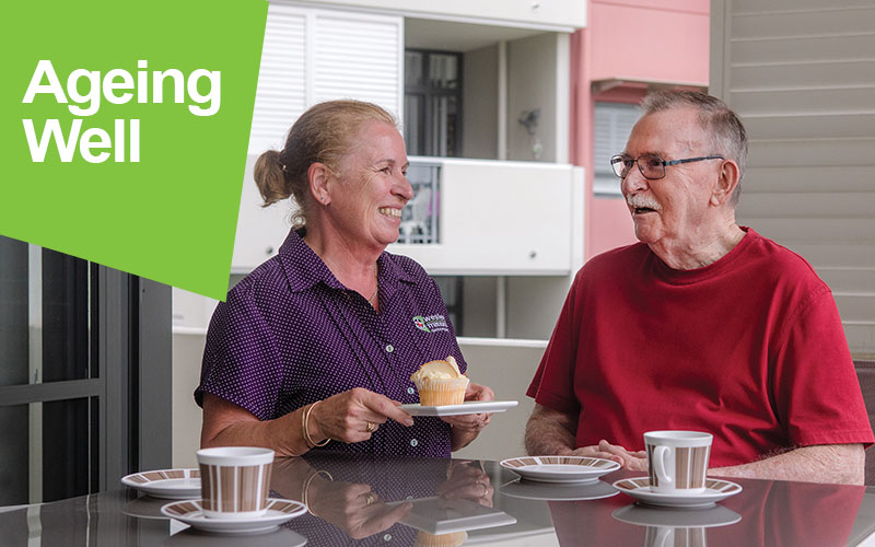 Aged Care worker having tea with a retiree at his home for some companionship.