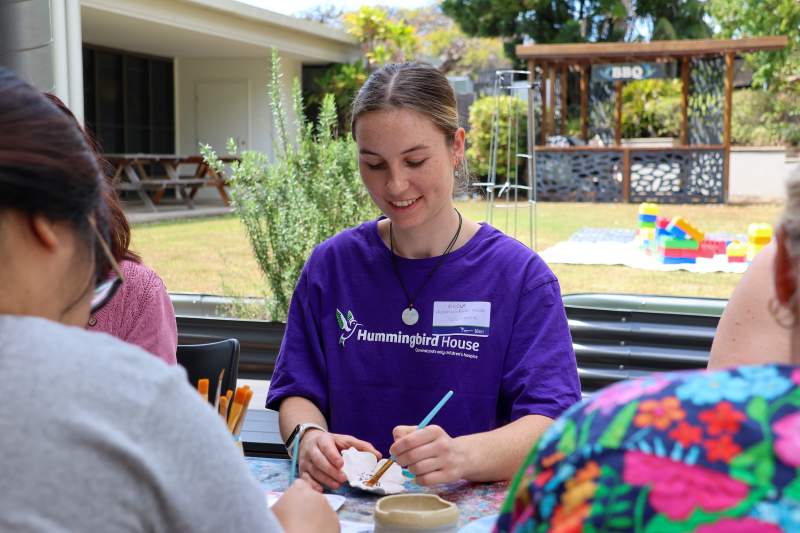 Arts and crafts at Hummingbird House 10-year celebration Hummingbird House staff painting a ceramic flower
