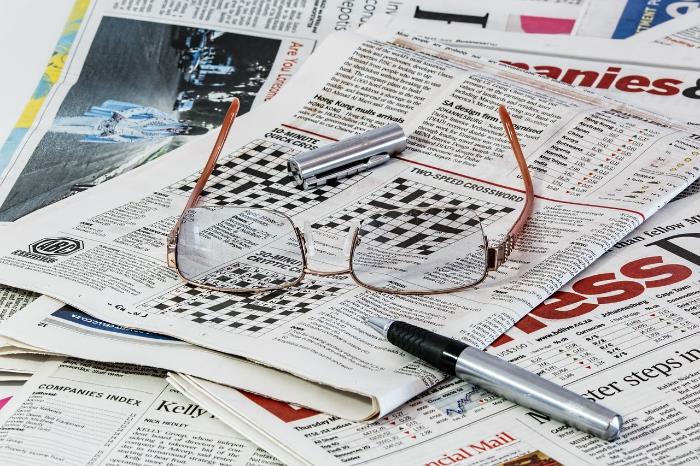 newspaper and reading glasses