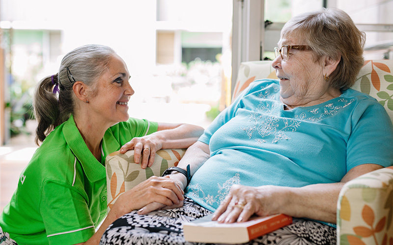 Staff talking to resident symbolises updates on residential aged care reforms news Staff talking to resident symbolises updates on residential aged care reforms news