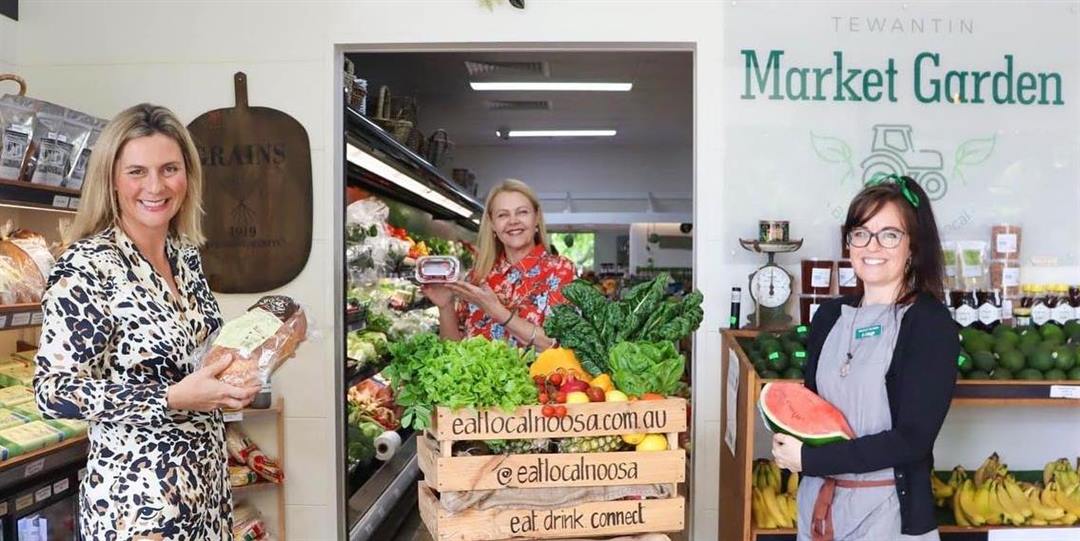 three women in a supermarket with fresh produce