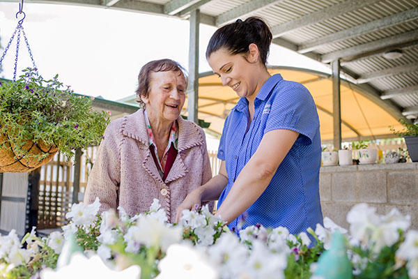 Image representing jobs and careers at Wesley Mission Queensland, Brisbane. It shows staff gardening flowers with aged care resident